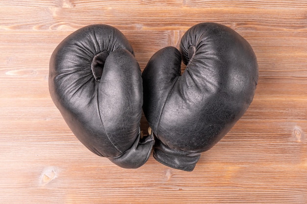 A pair of boxing gloves on a wooden table