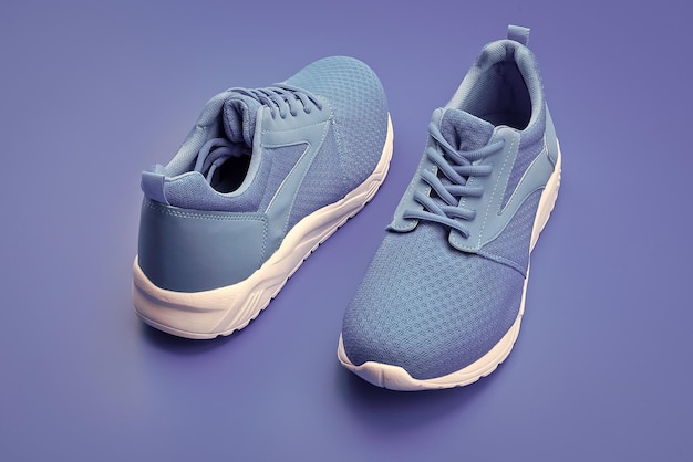 Pair of comfortable blue sport shoes on blue background shoe store