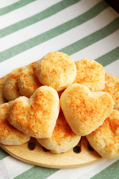 Pair of Delectable Heart Shaped Fresh Baked Pao de Queijo or Brazilian Cheese Breads on the Pile