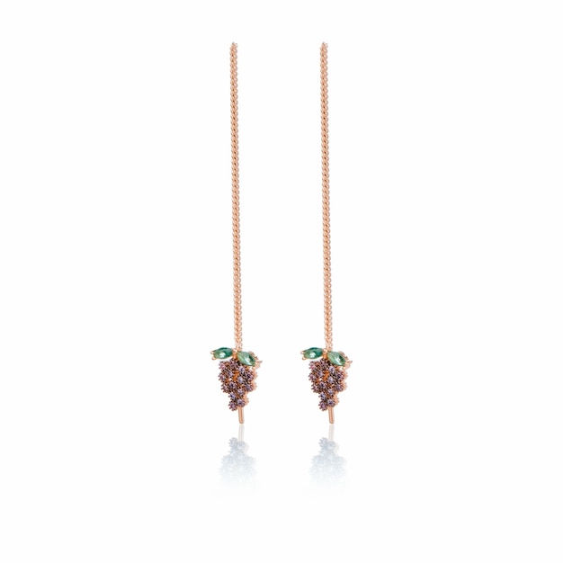 A pair of earrings with green gemstones