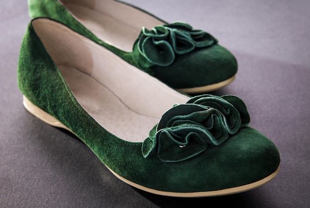 A pair of green suede flats