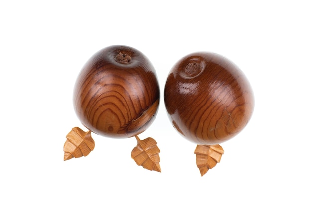 A pair of hand carved wood fruit with leaves