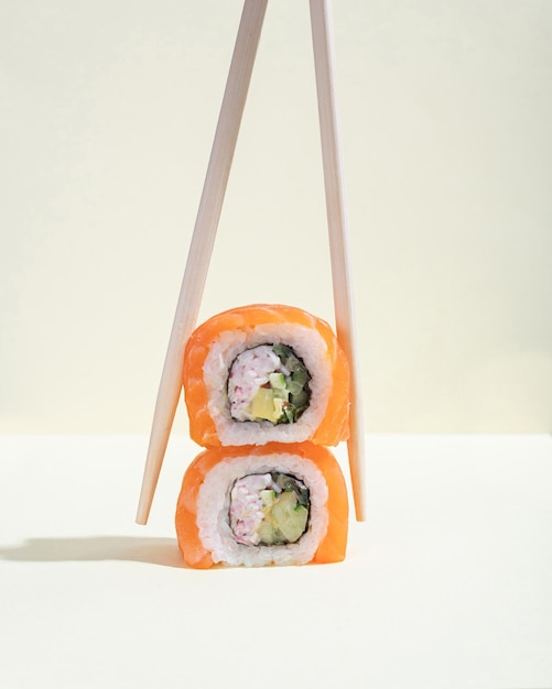 A pair of Japanese salmon sushi dragon rolls on a bright yellow background Pop art