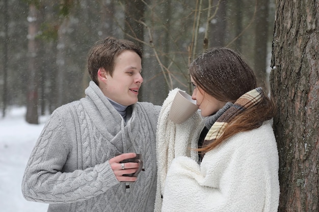 A pair of lovers on a date winter afternoon in a snow blizzard