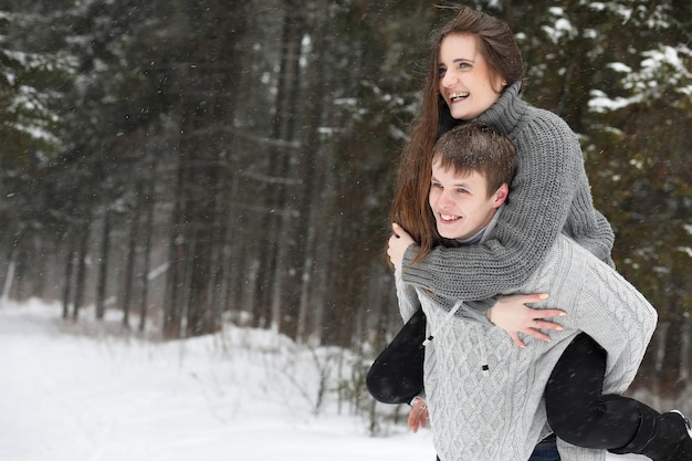 A pair of lovers on a date winter afternoon in a snow blizzard