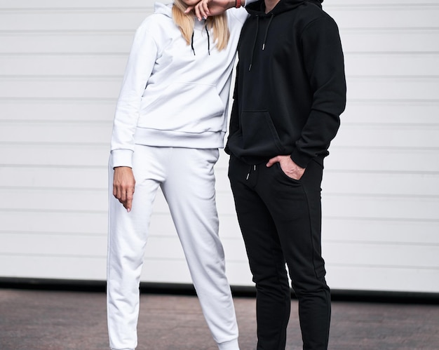 Pair of man and woman is wearing hooded sweatshirt Copy space hoodie design for branding clothes