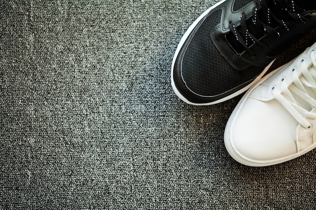 Pair of new stylish sneakers on floor at home.