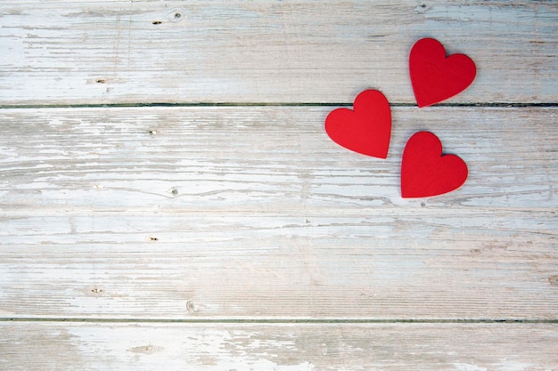 Pair of red hearts on vintage wooden table top view Saint Valentines day Valentines Day