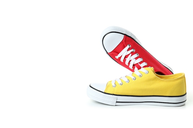 Pair of red and yellow sneakers isolated on white background