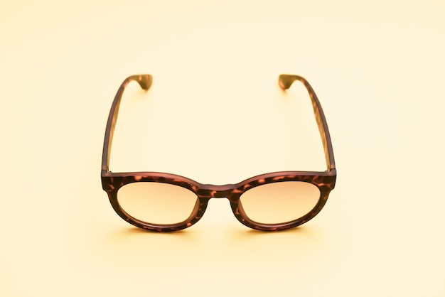 A pair of tortoises shell style fashion glasses isolated on light color background. 