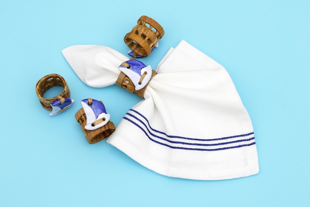 A pair of white and blue striped baby headbands with a white and blue striped towel.