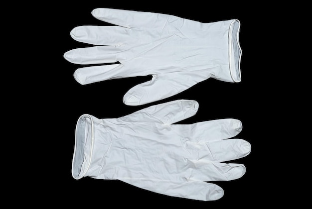 Pair of white latex gloves on a dark background