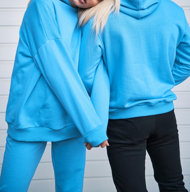 Pair of woman and man wear a no logo hoodie sweatshirt design template copy space street wear clothing