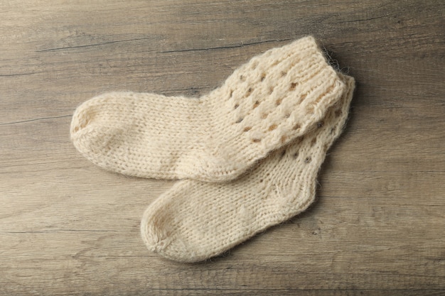 Pair of woolen socks on wooden background