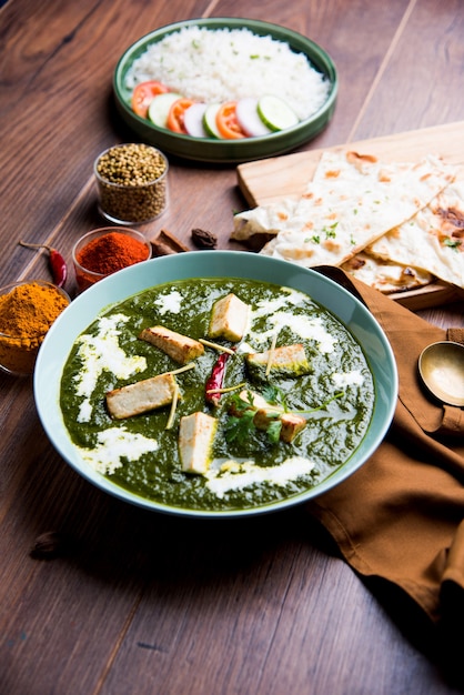 Palak Paneer Masala is a popular North Indian recipe for lunch dinner made using cottage cheese in green spinach curry. usually served with Rice and chapati naan. selective focus