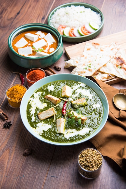 Palak Paneer Masala is a popular North Indian recipe for lunch dinner made using cottage cheese in green spinach curry. usually served with Rice and chapati naan. selective focus