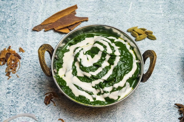 Palak Paneer or saag majhani served in a karahi isolated on grey background top view of bangladesh food