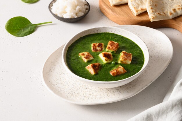 Palak paneer served basmati rice on white