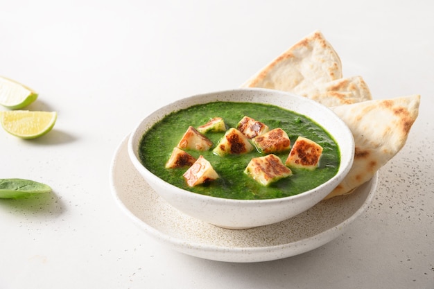 Palak paneer served basmati rice on white