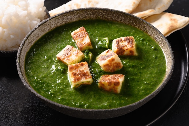 Palak paneer of spinach and cheese on black