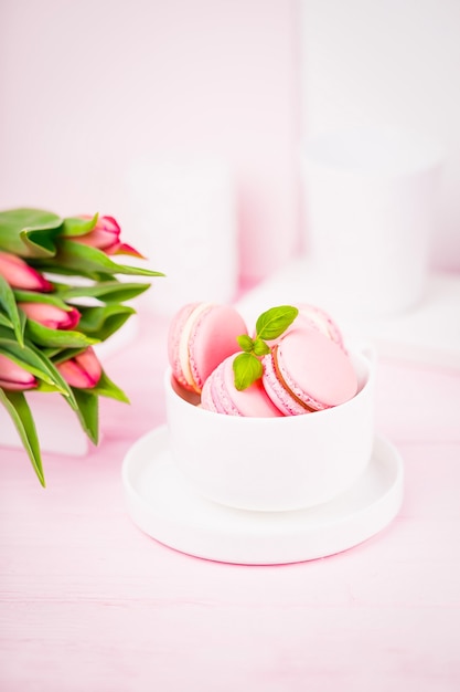 Pale pink macaroons or macarons and spring tulips