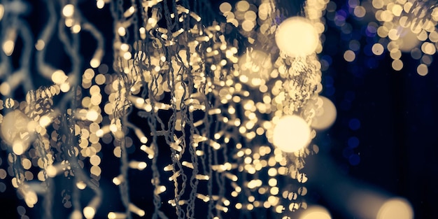 Pale yellow lights bokeh from christmas holiday garlands blurred festive abstract background lights