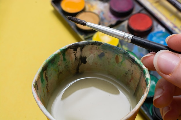 Palette and bucket for drawing with watercolor paints Hobbies and creativity education art