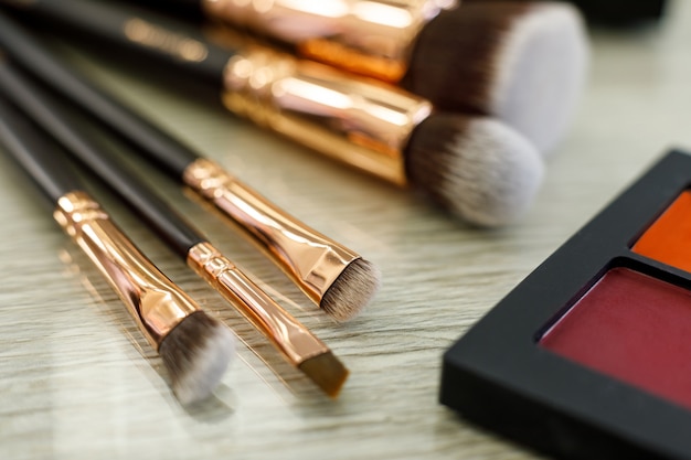 Palette with shadows and brushes on the table in the beauty salon