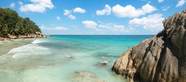 Palm and tropical beach panorama Anse Lazio beach at Praslin island Seychelles long exposure vintage toning Palm and tropical beach vacation travel concept