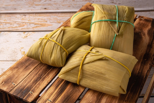 Pamonha cornbased Brazilian food arranged on a rustic wooden table selective focus