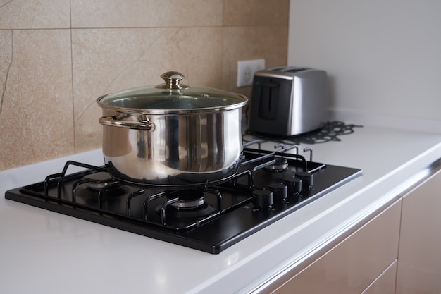 Pan on the gas stove in kitchen interior stainless steel pot cooking utensils concept