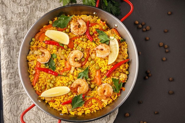 A pan of paella with shrimps and rice