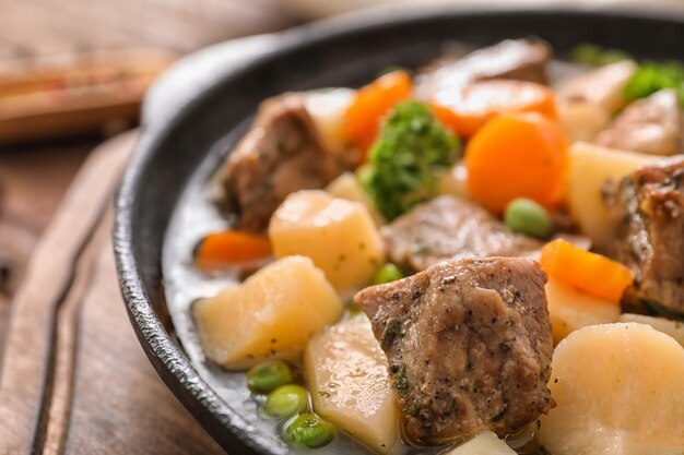 Pan with stewed meat and potatoes closeup