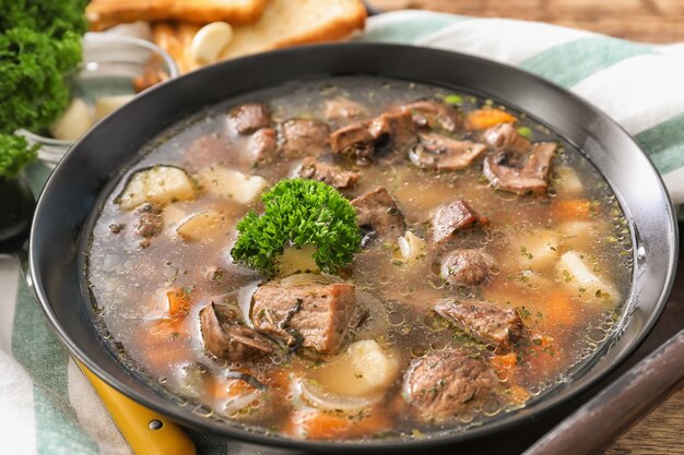 Pan with stewed meat and potatoes on table