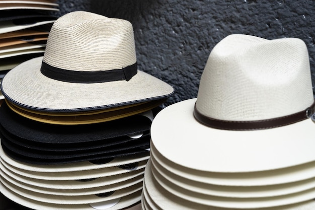 Panama hats piled up on street store. Men colorful accessories stack, souvenir concepts