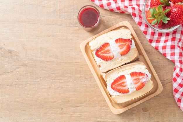 pancake sandwich strawberry fresh cream on wood plate