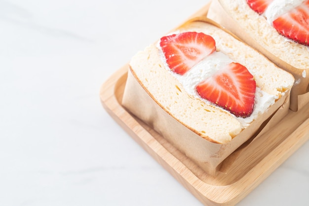 pancake sandwich strawberry fresh cream on wood plate