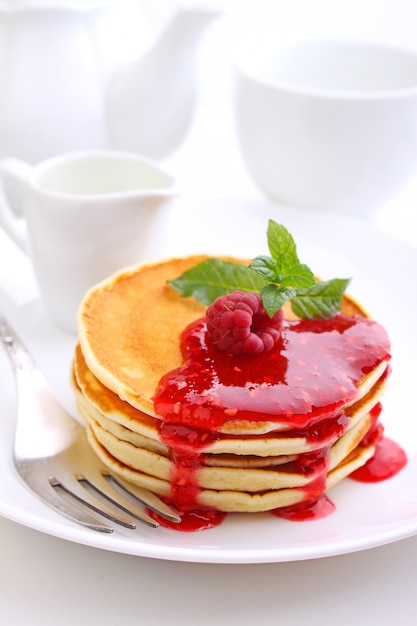 Pancake with berries blueberries in a plate on a white background