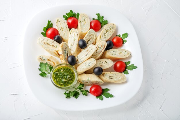 Pancake with feta cheese and herbs and pesto. Top view. The conc