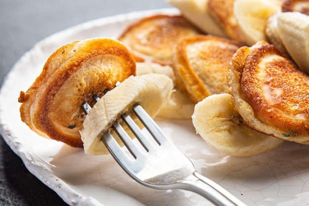 Pancakes banana slices syrup or honey delicious breakfast sweet dessert fresh portion ready to eat