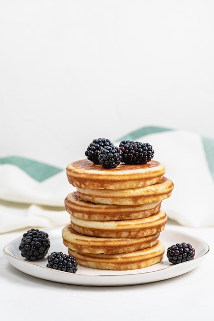 Pancakes on plate with blackberries Healthy breakfast with fruits