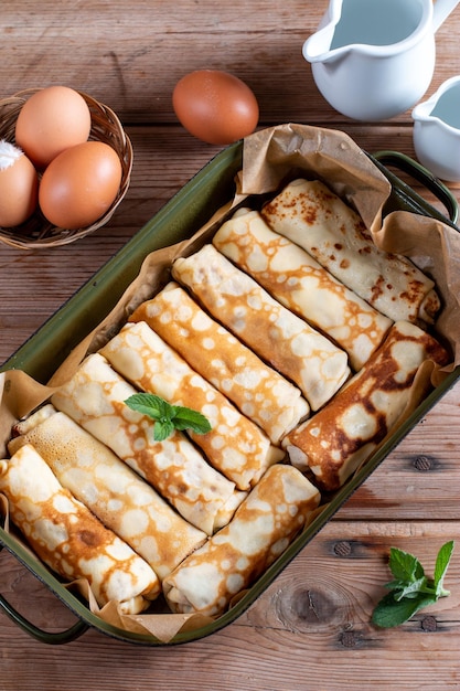 Pancakes rolls with cottage cheese on wooden table Pancakes with cheese Shrovetide