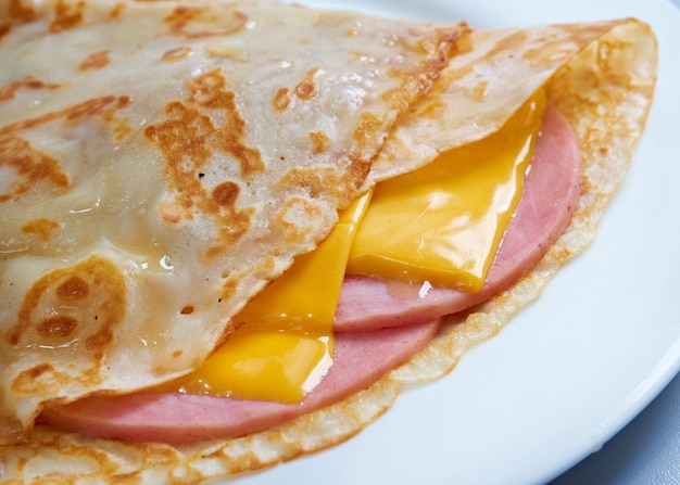 Pancakes stuffed ham and cheese. Shallow depth-of-field.