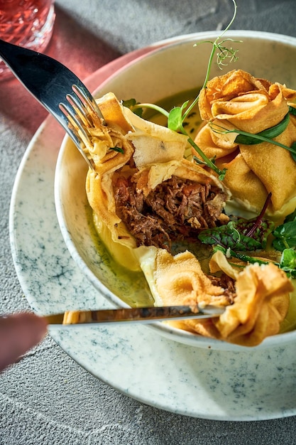 Pancakes stuffed with minced meat and sauce in a plate Concrete background Ukrainian Blini Crepe rolls with meat