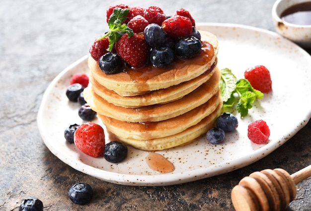 Pancakes with berries and maple syrup