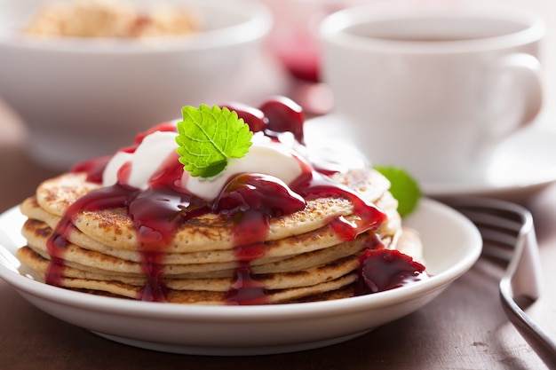 Pancakes with cherry jam and cream