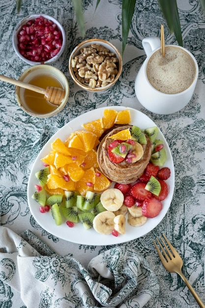 Pancakes with fresh fruit. Fruit salad with gluten-free pancakes. Healthy breakfast full of vitamins