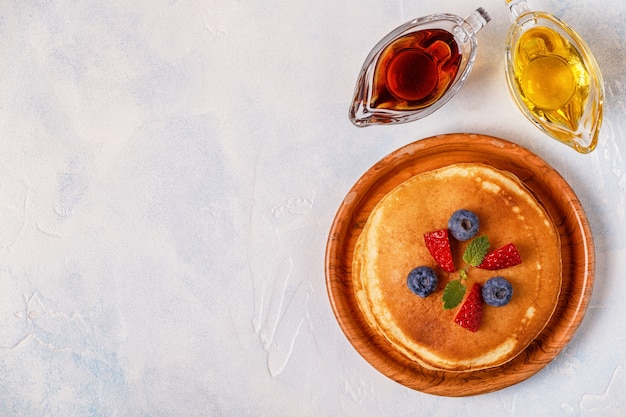 Pancakes with fruit, honey, maple syrup