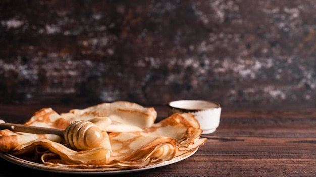 Pancakes with honey on a plate Maslenitsa Copy space