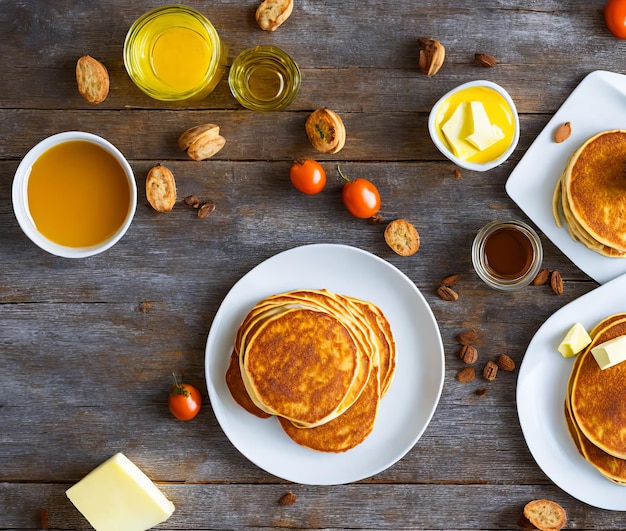 Pancakes with honey and tea on a white plate top view